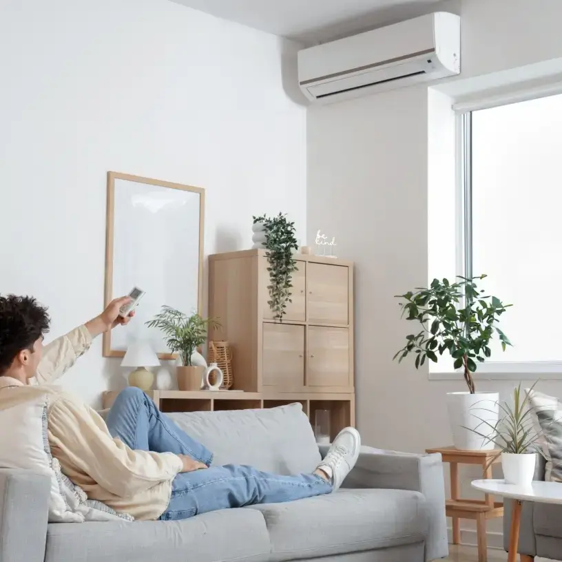 Man turning on energy efficient air conditioner